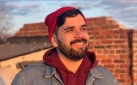 Person in red hat smiling outdoors