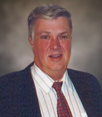 Portrait of a man in a suit and tie.