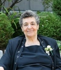 Elderly woman sitting outdoors in a garden