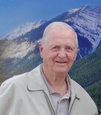 Smiling man with mountains in the background.