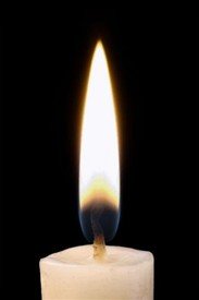 Candle flame burning in darkness